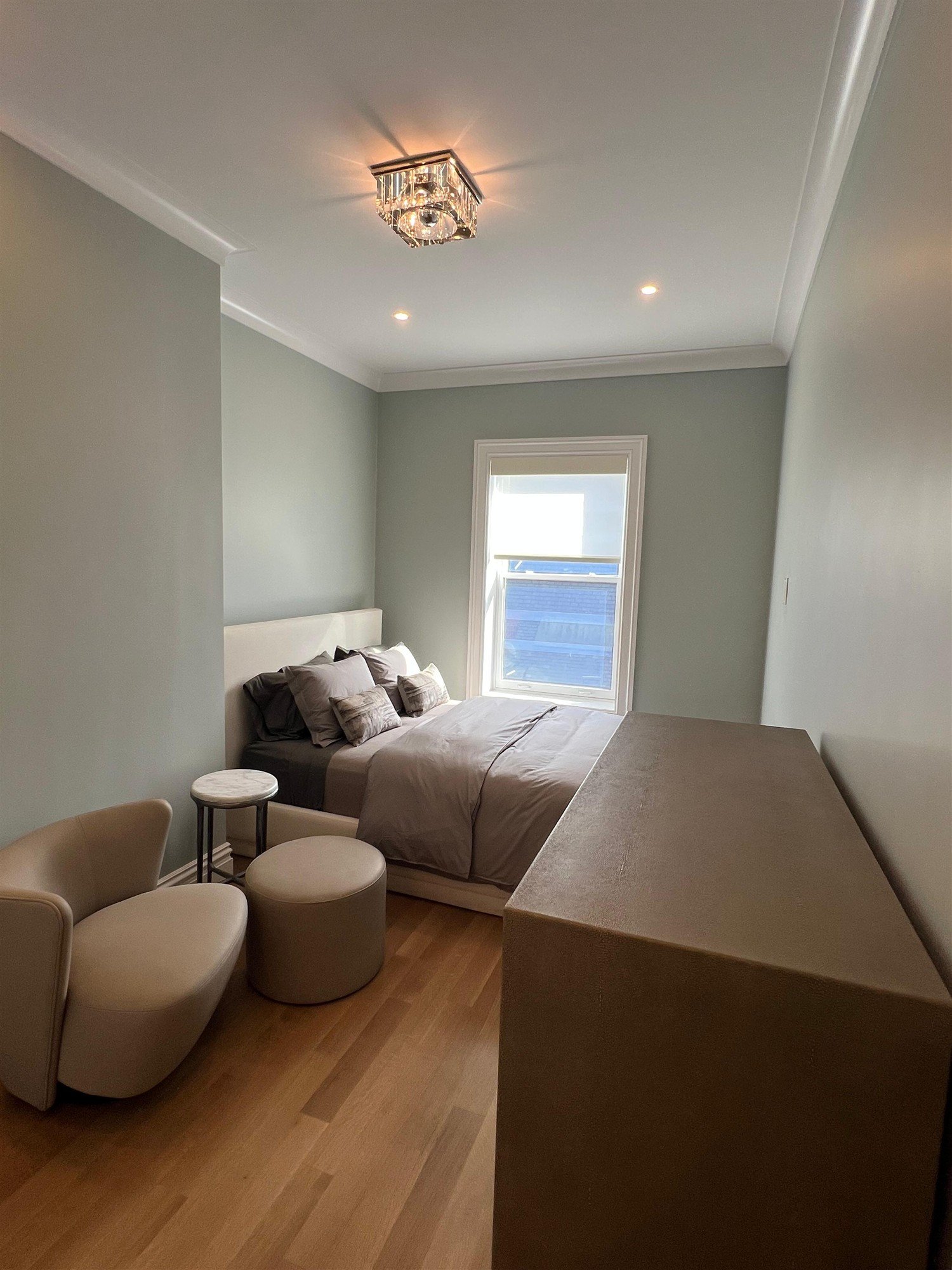 Soft green bedroom walls with white trim